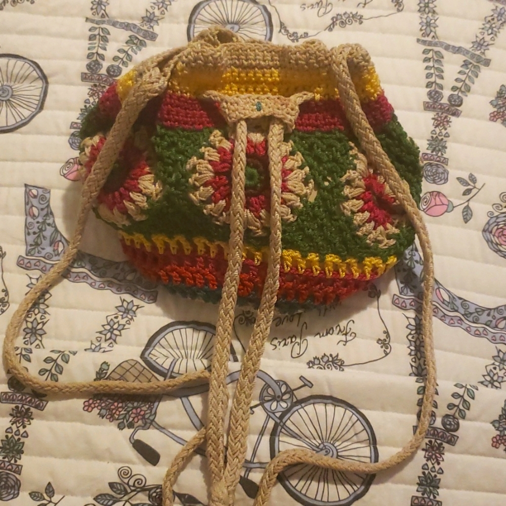 The Sak...  crocheted  bag multicolored  drawstring and snap button closure.